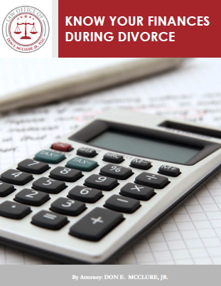 Know Your Finances During Divorce by Attorney: Don E. McClure, Jr., calculator on top of graph paper