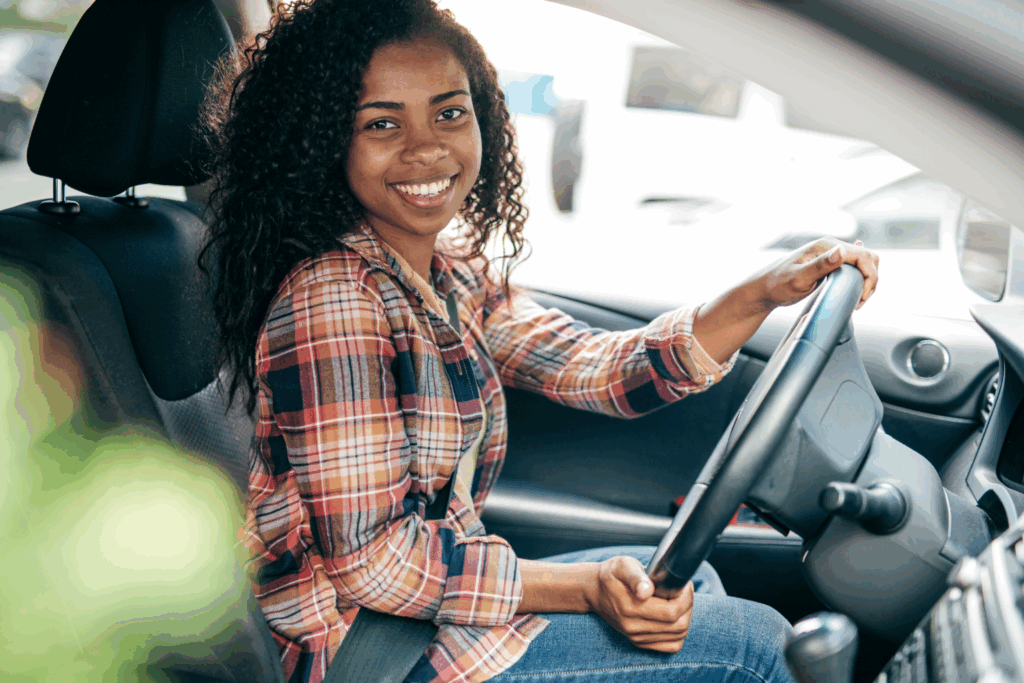 Smiling new driver in Houston learning safe habits to avoid common mistakes new drivers make