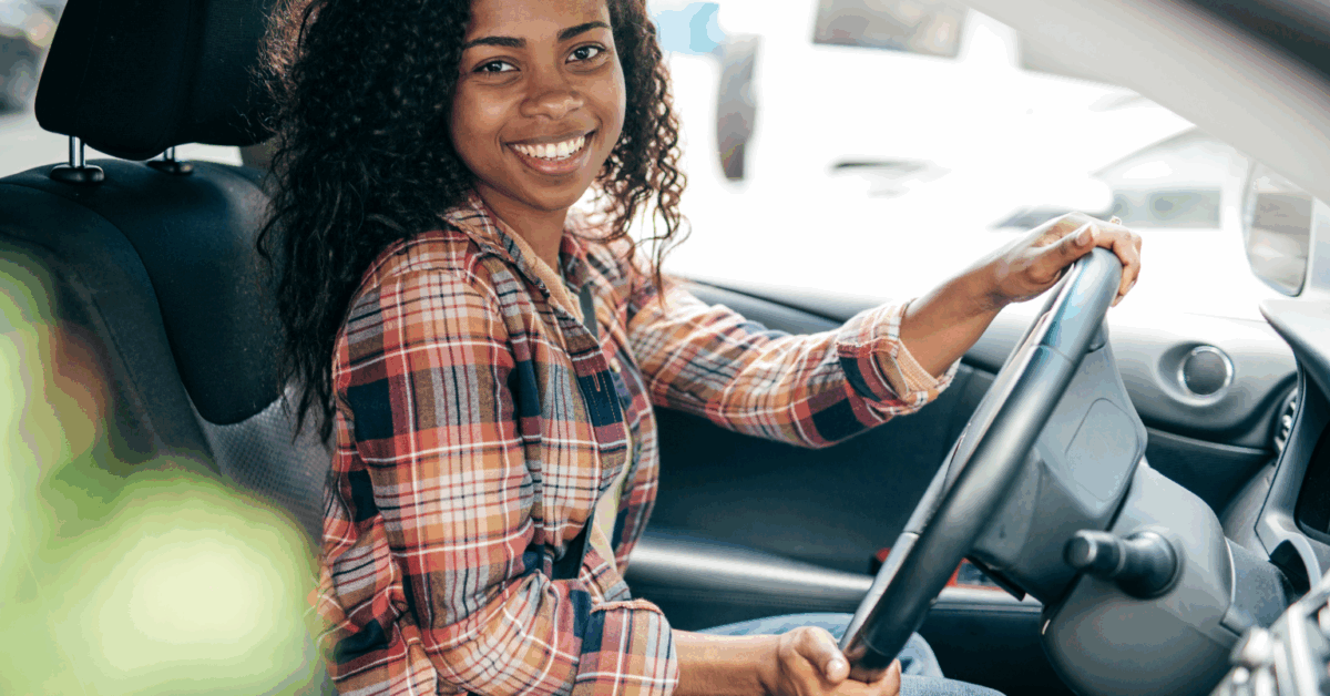 Smiling new driver in Houston learning safe habits to avoid common mistakes new drivers make
