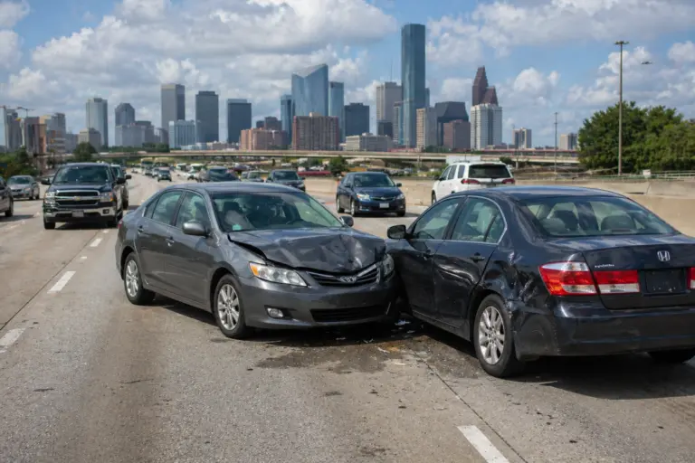 Damaged cars after a Houston car accident on a busy Texas roadway