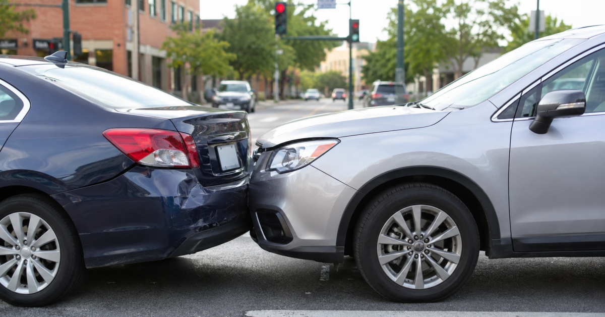 Minor fender bender car accident in Texas showing two vehicles with light bumper damage at an urban intersection.